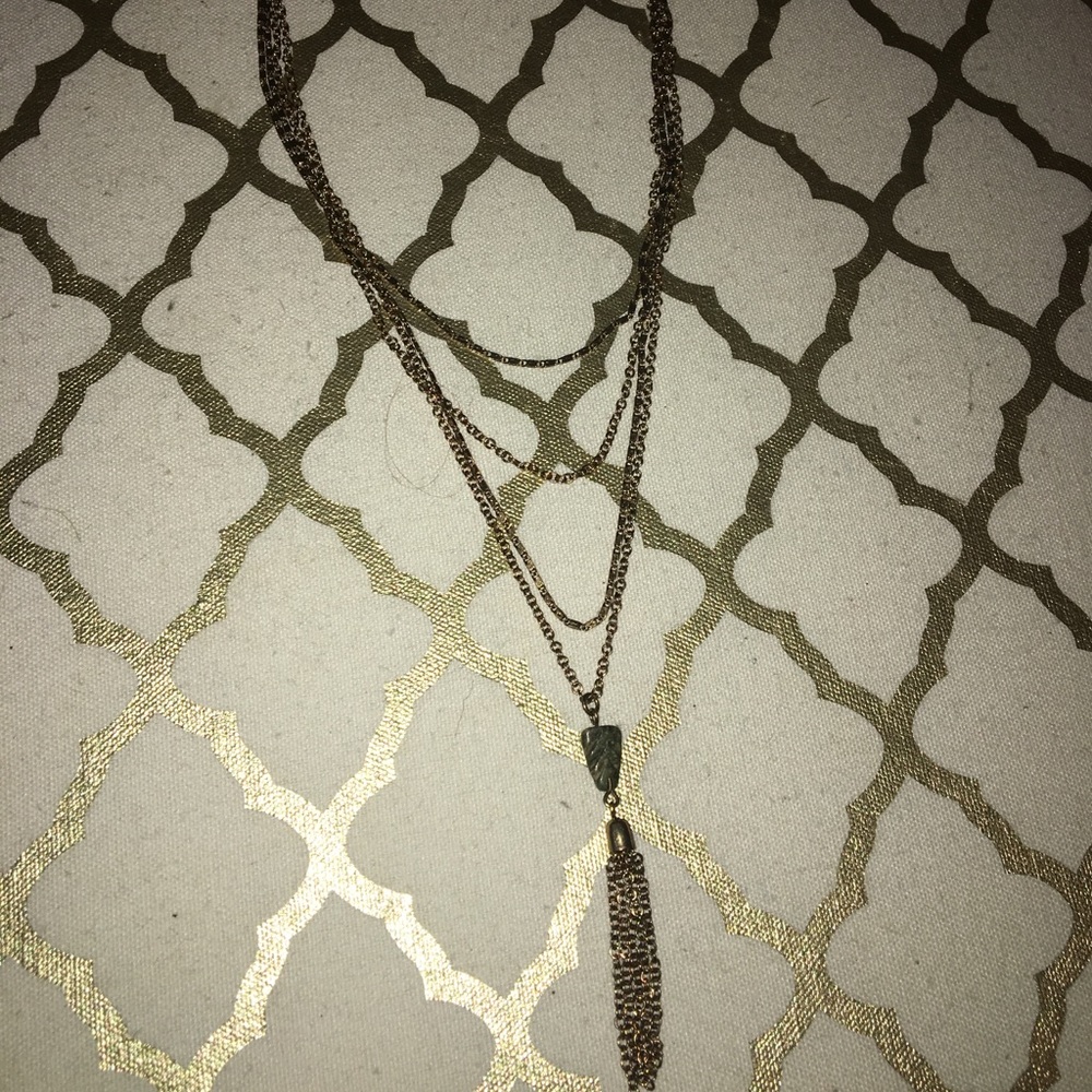 Four layer necklace with a pendant.